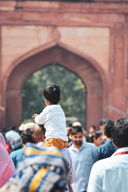 Free Selective Focus Photo of Kid Carried by a Man Stock Photo