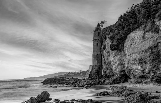Dramatic black and white photo of Victoria Beach's famous Pirate Tower in Laguna Beach, CA.