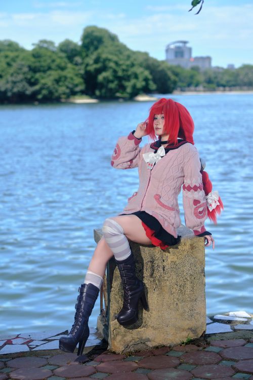 Free Cosplayer in an anime-inspired outfit by a serene lake, showcasing vibrant colors. Stock Photo