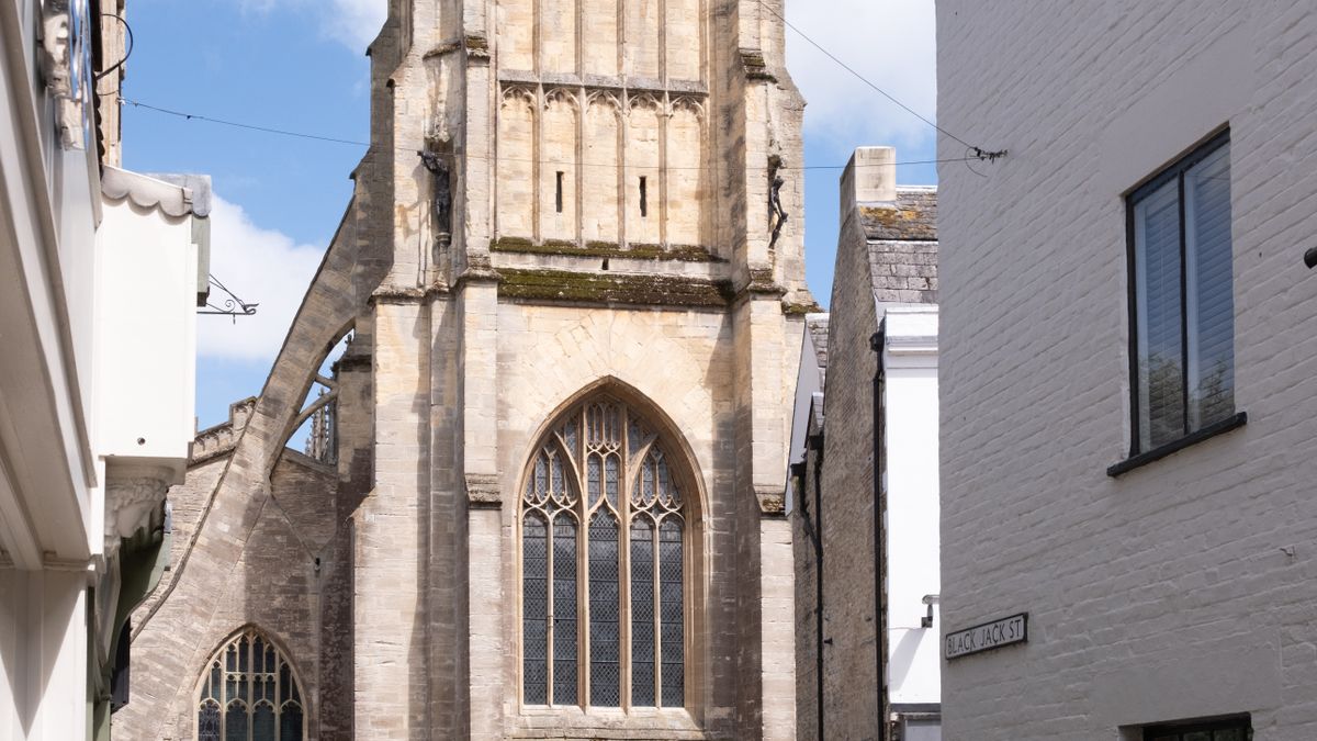 The Church of St John the Baptist at the end of a street in Cirencester, the centre of a Cirencester weekend break