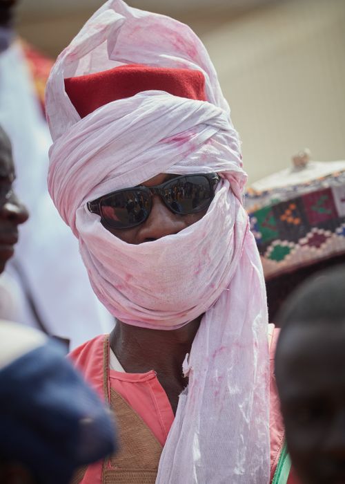 Free Close-up of a person wearing a traditional turban and sunglasses at a cultural event. Stock Photo