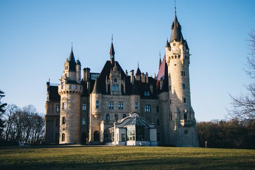Free Captivating view of Moszna Castle, Poland, basking in morning light. Stock Photo