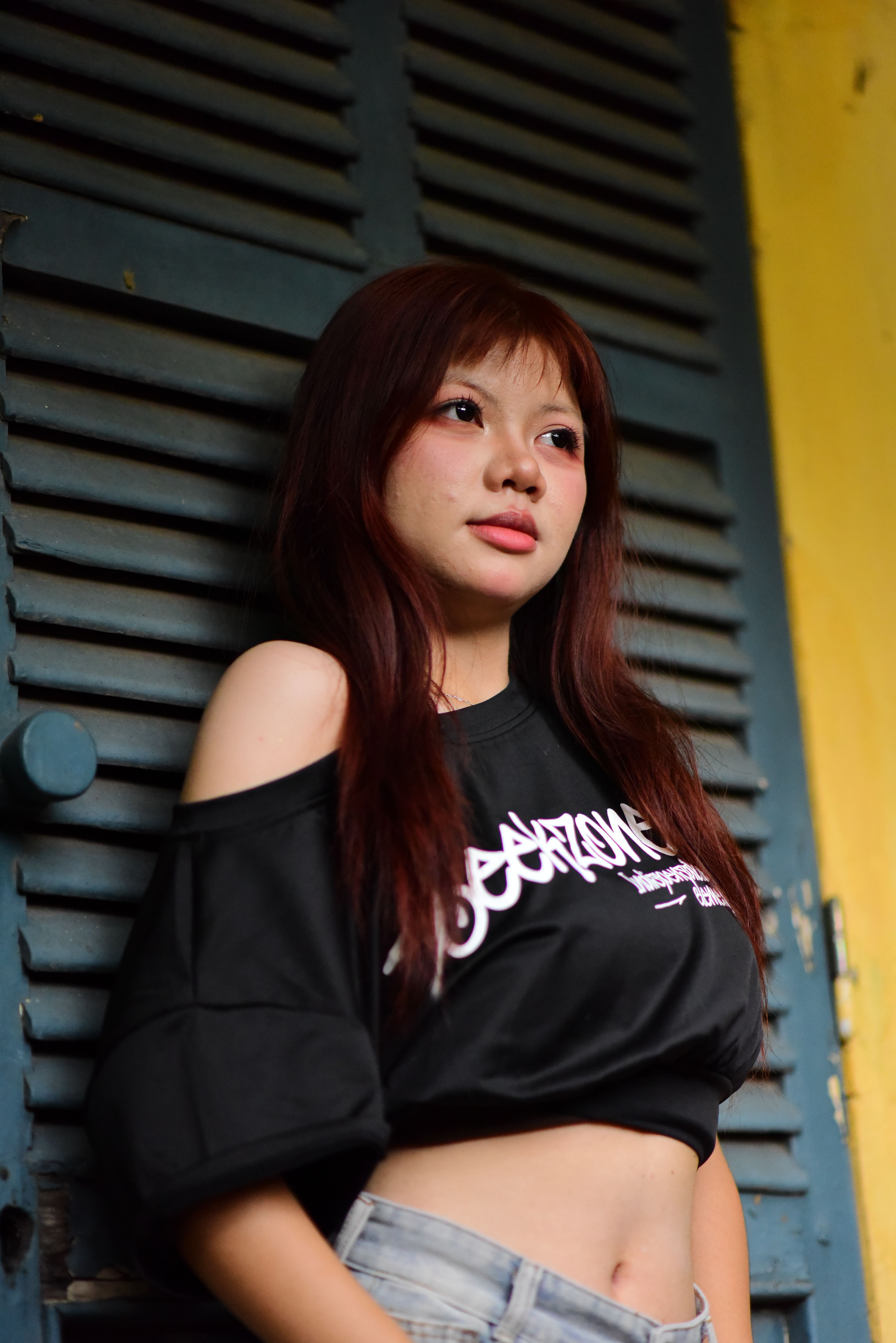 Young Woman Portrait Against Blue Shutter