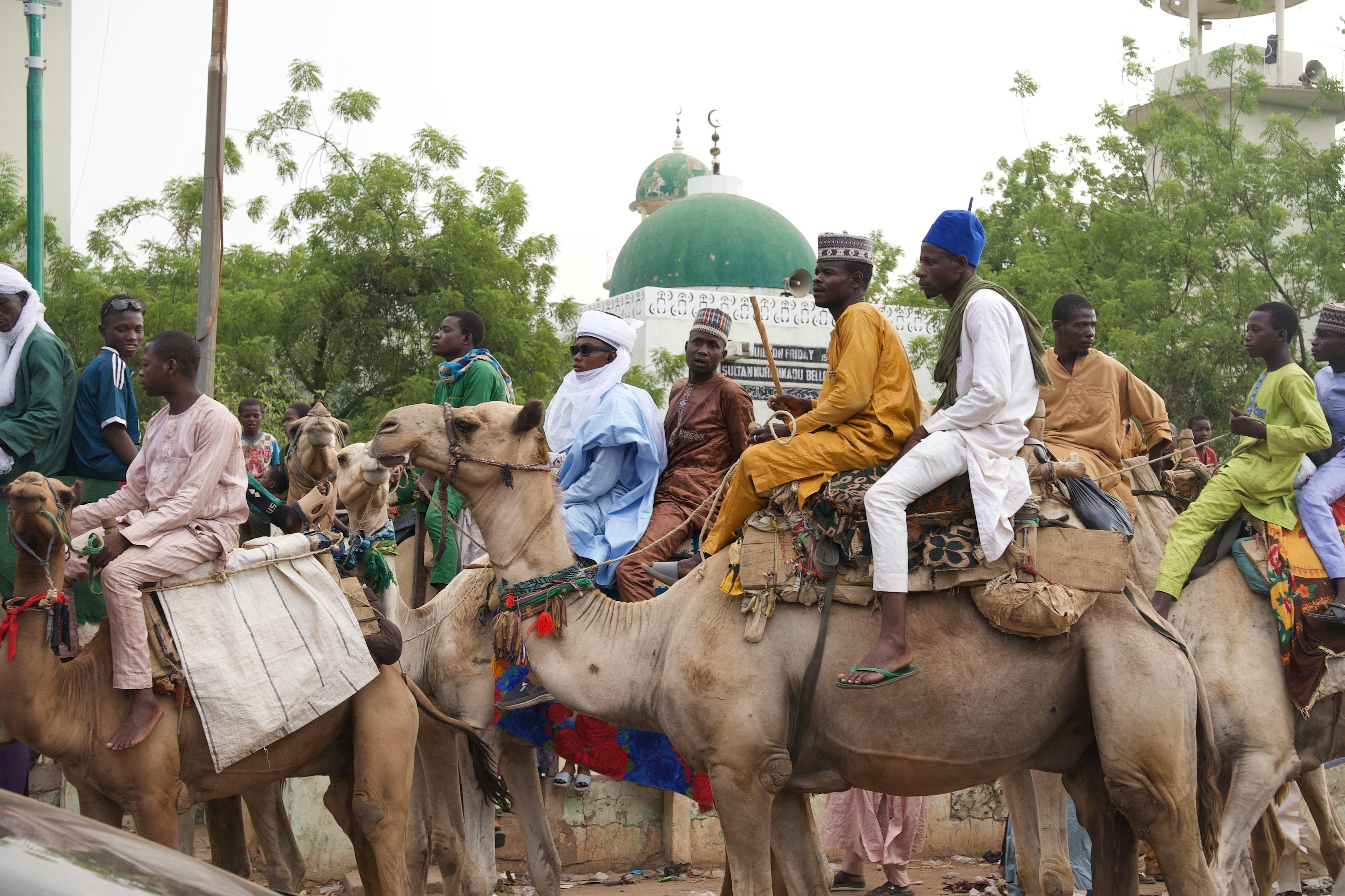 Vibrant depiction of traditional horse riders in Sokoto, showcasing cultural attire and local customs.