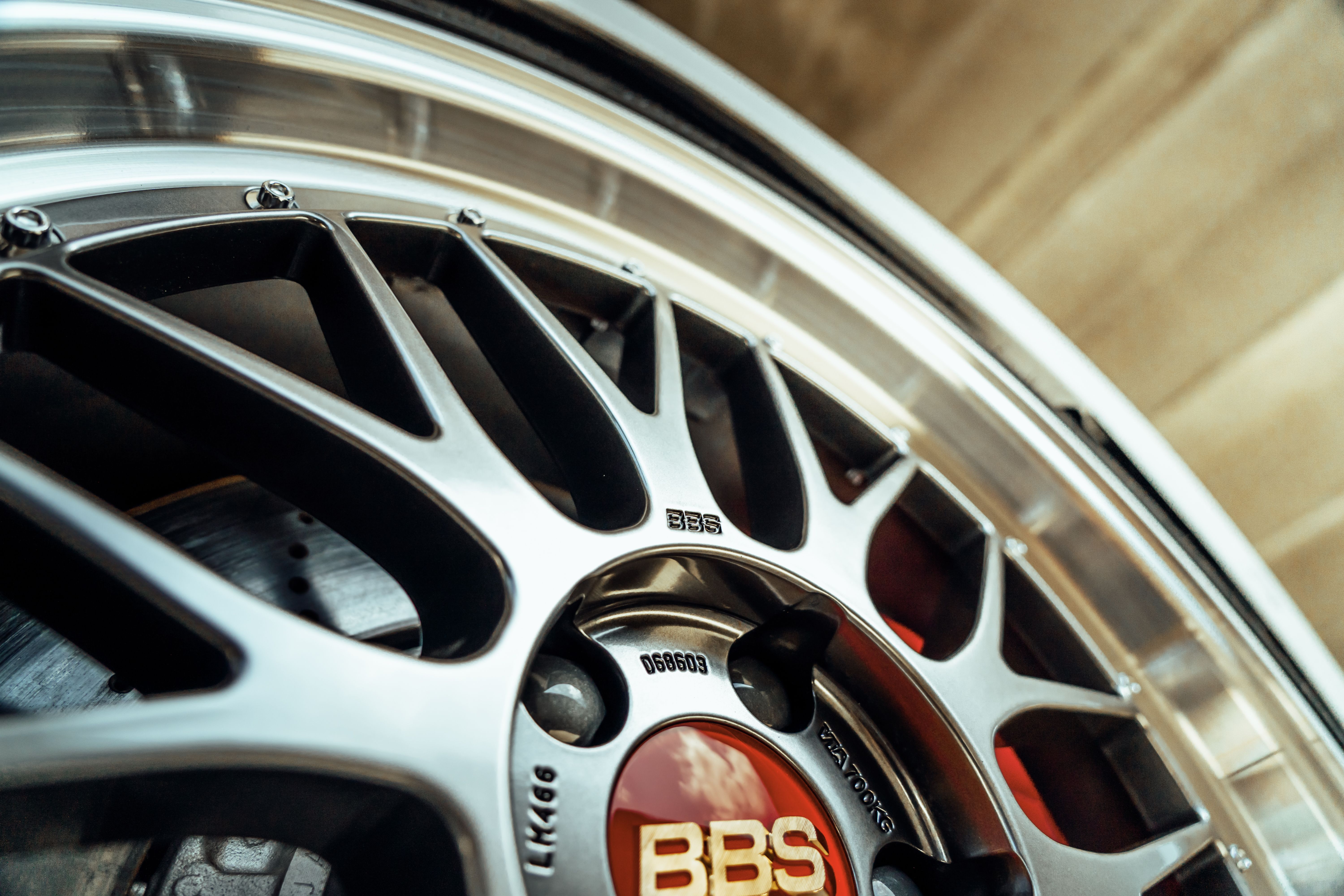 Detailed photograph of a stylish BBS alloy wheel rim, showing intricate design and branding.