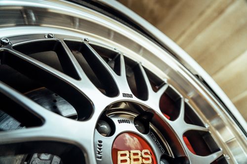 Free Detailed photograph of a stylish BBS alloy wheel rim, showing intricate design and branding. Stock Photo