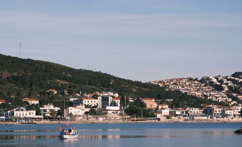 Free Charming coastal town of Foça in İzmir, Türkiye, captured with a serene sea view and hillside houses. Stock Photo