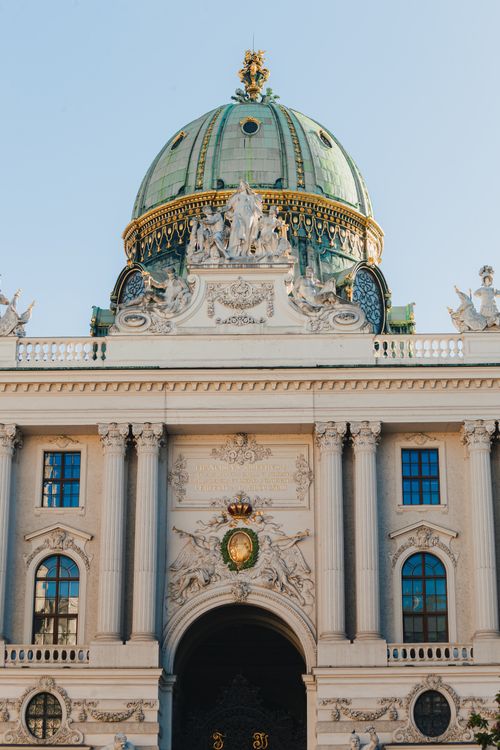 Free Elegant view of the historic Hofburg Palace in Vienna showcasing its majestic dome and detailed facade. Stock Photo
