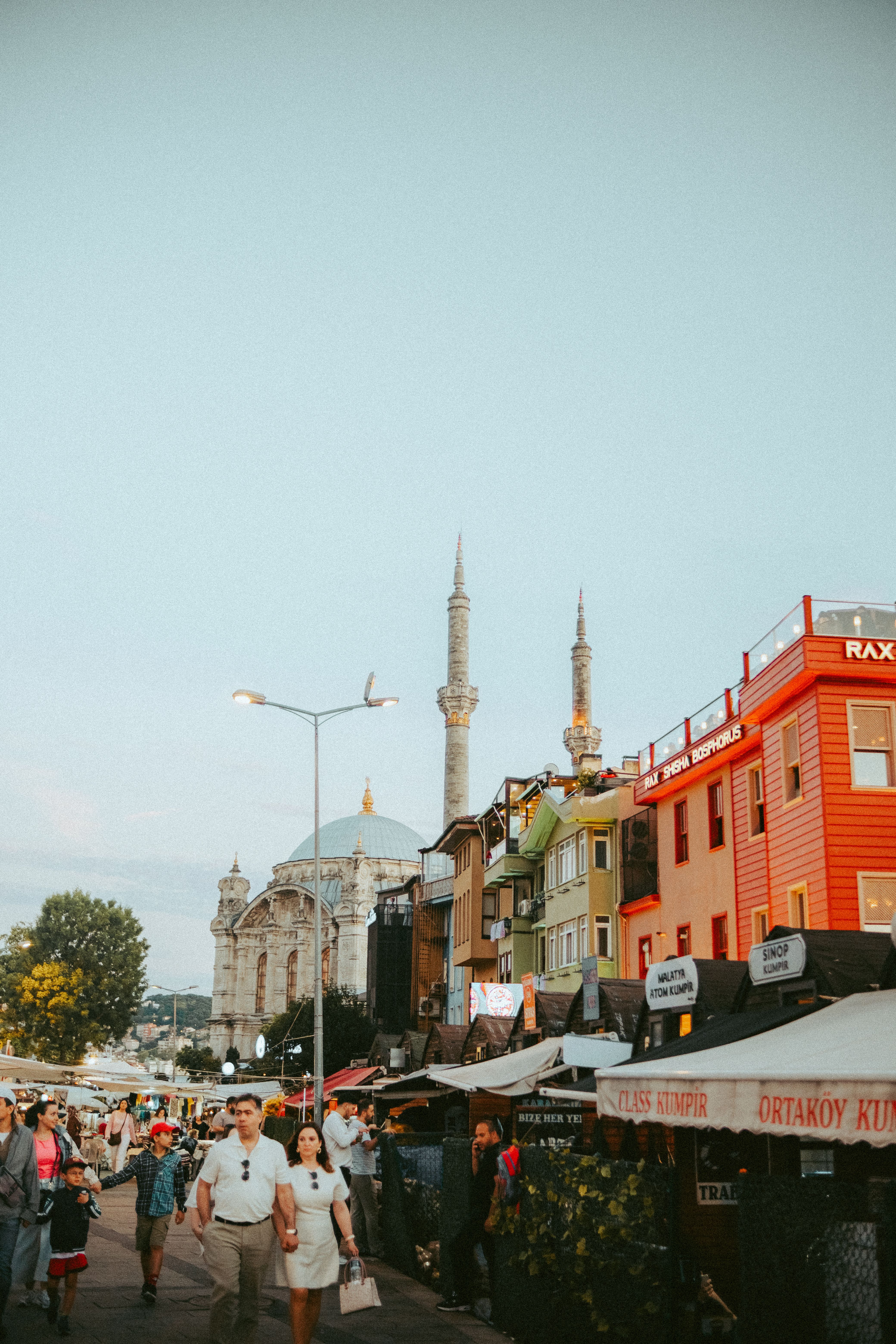 A lively street scene in Istanbul featuring a mosque and colorful buildings, capturing the vibrant atmosphere.