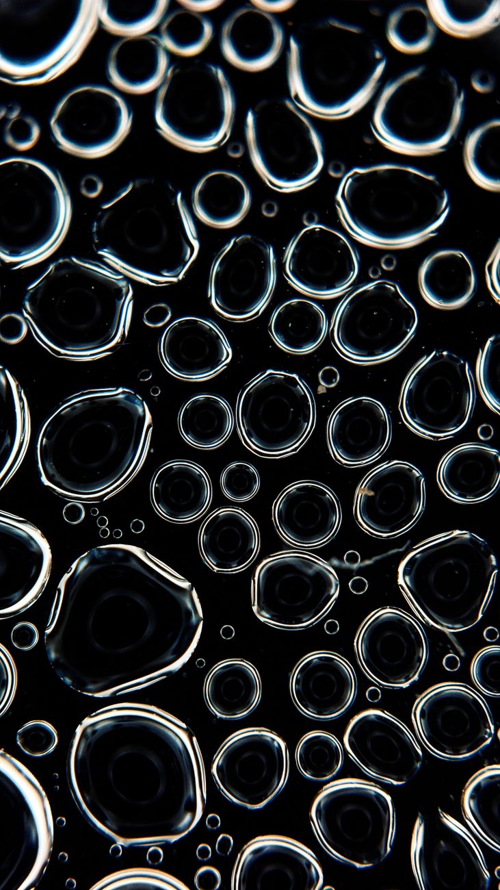 Intriguing macro shot capturing detailed surface tension patterns in water bubbles.. intriguing, macro, shot