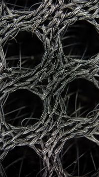 Detailed macro shot showcasing a complex interlocking pattern of metallic fibers.