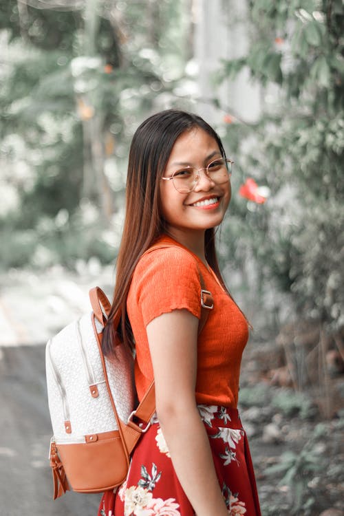Free Woman Smiling While Carrying a Backpack Stock Photo