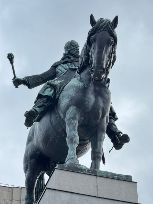 Free A striking equestrian statue of a historical figure framed against a cloudy sky, exuding power. Stock Photo