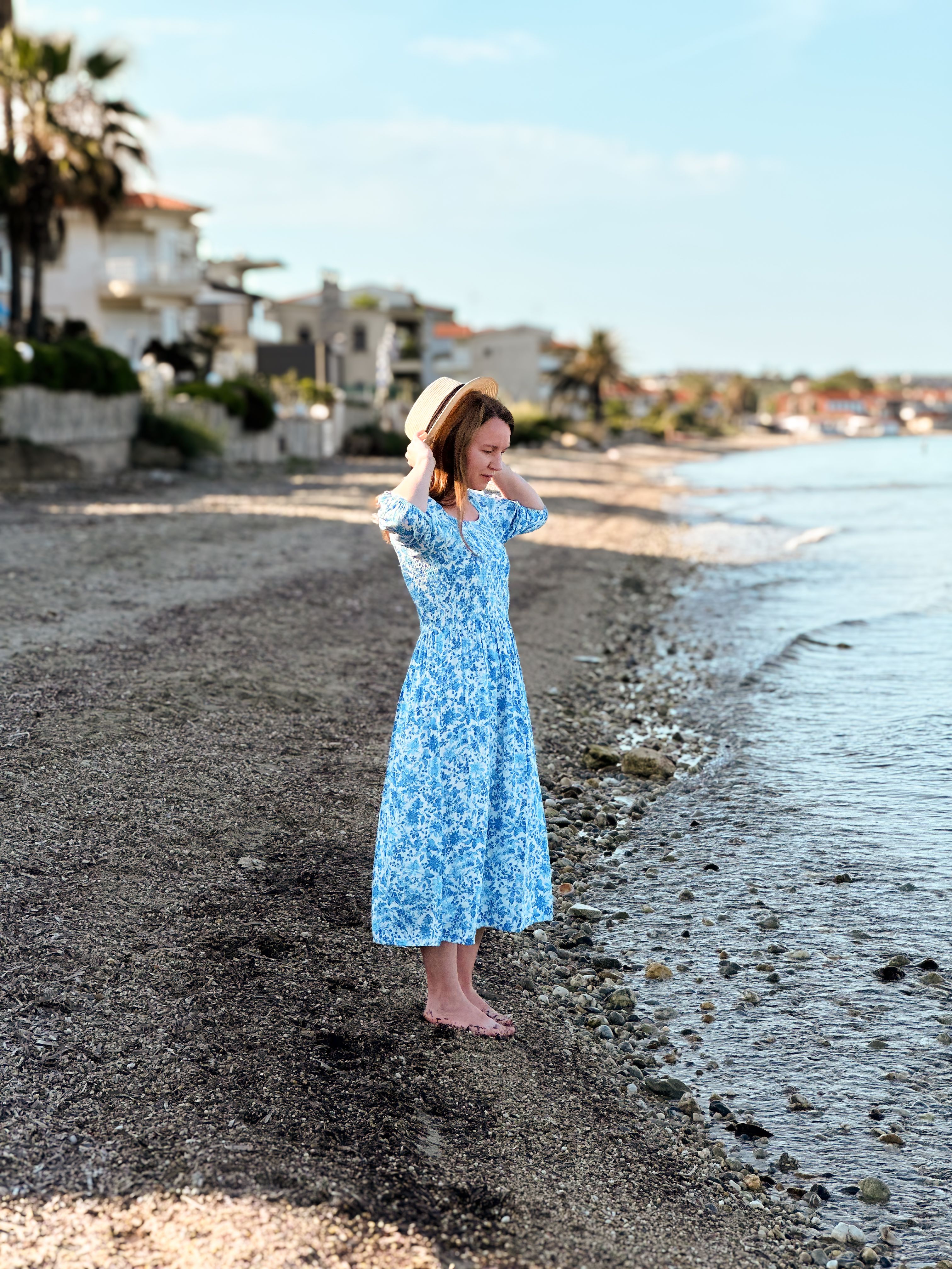 Woman in Blue Dress Strolls on Serene Beach · Free Stock Photo