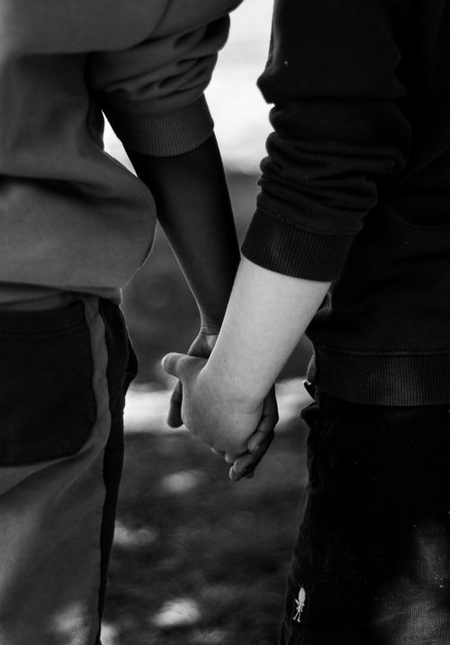 Free A touching black and white photograph depicting unity through hand holding. Stock Photo