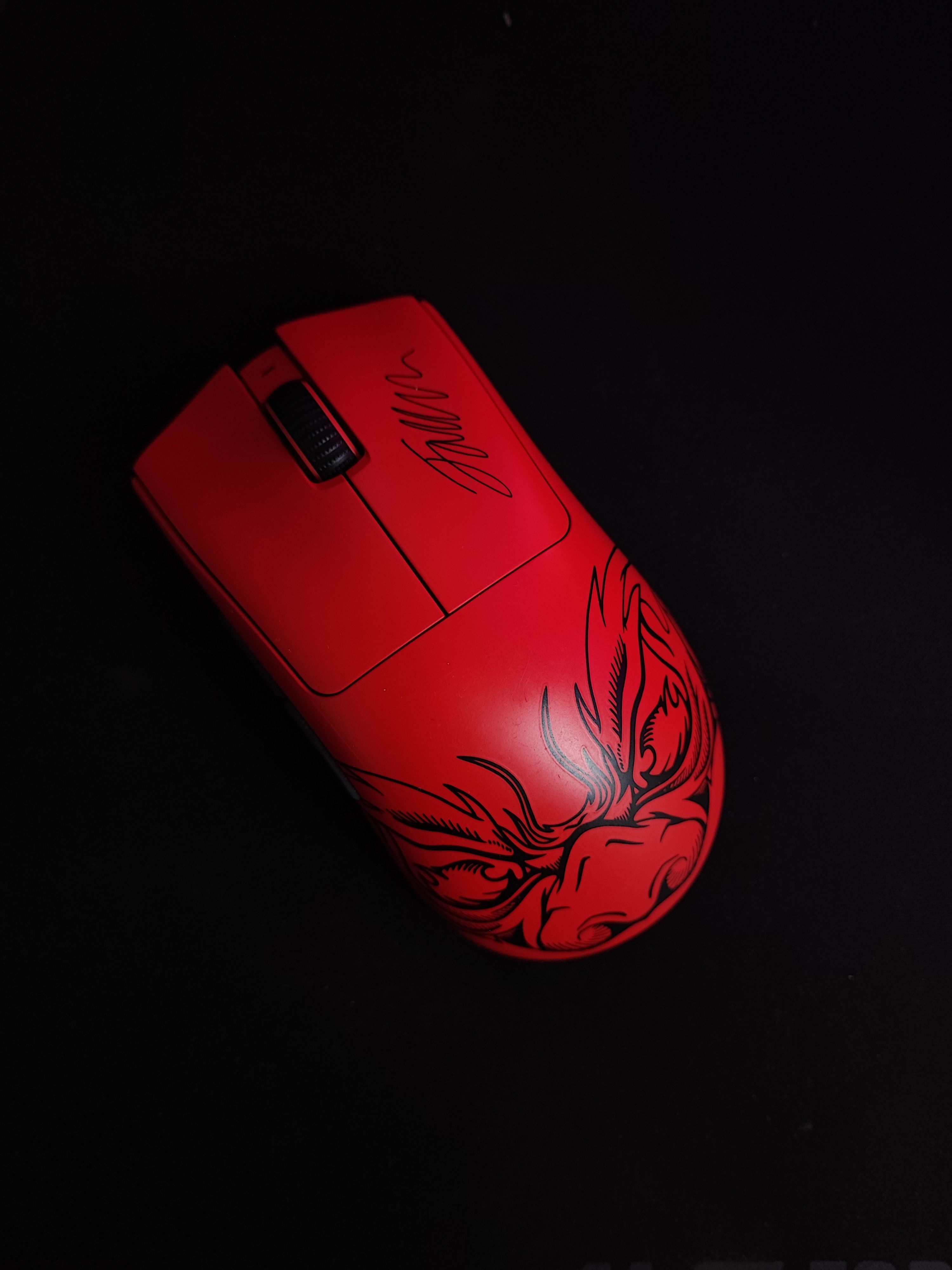 Striking red gaming mouse featuring a unique custom design, perfect for esports enthusiasts.