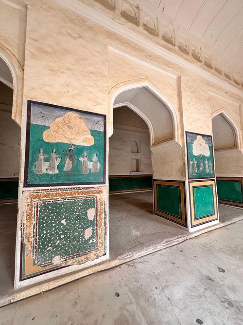 Free Intricate wall paintings and arches in a historic Rajasthan building interior. Stock Photo