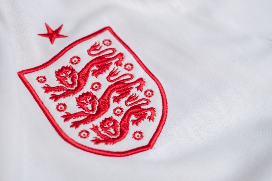 Detailed look at the England national football team's emblem on a jersey.