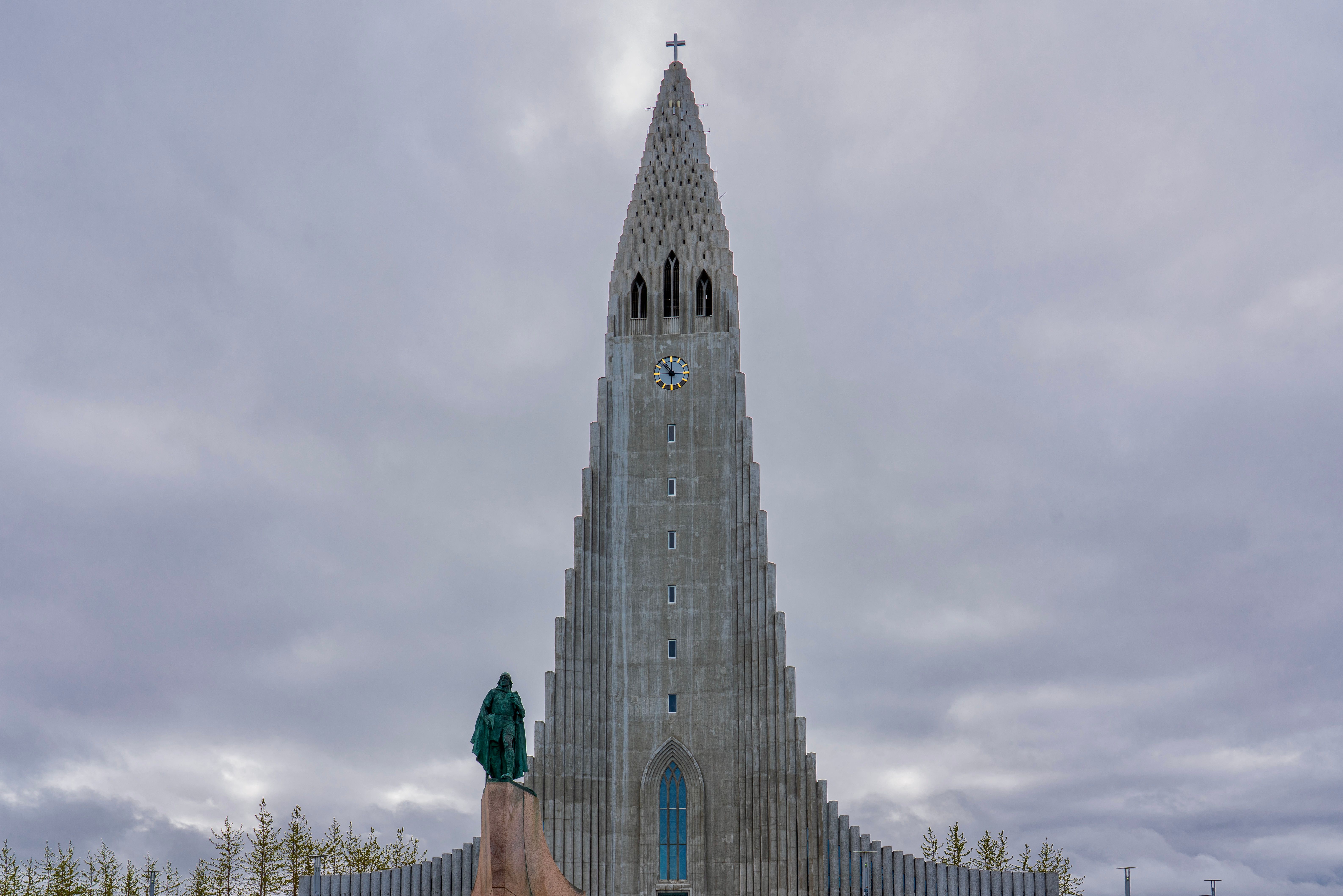 Dramatic view of Hallgrímskirkja church against cloudy skies in Reykjavik.