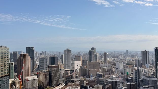 Discover the breathtaking skyline of Ōsaka, Japan, captured in clear daylight, showcasing modern architecture.