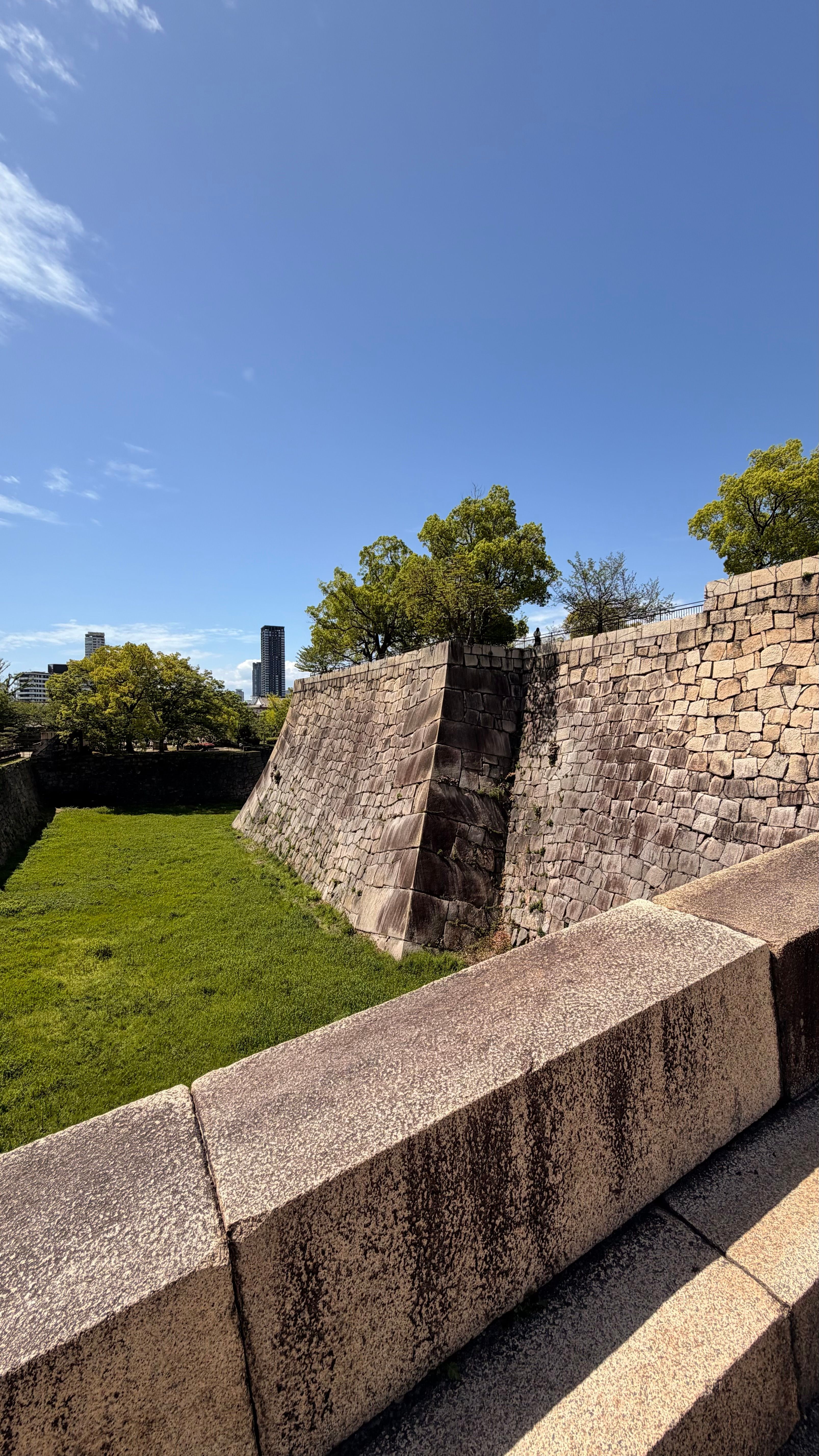 Captivating scene of the stone fortifications in Ōsaka Castle Park, showcasing historical architecture.