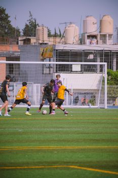 Young players competing in a soccer match on an outdoor turf field, showcasing teamwork and energy.
