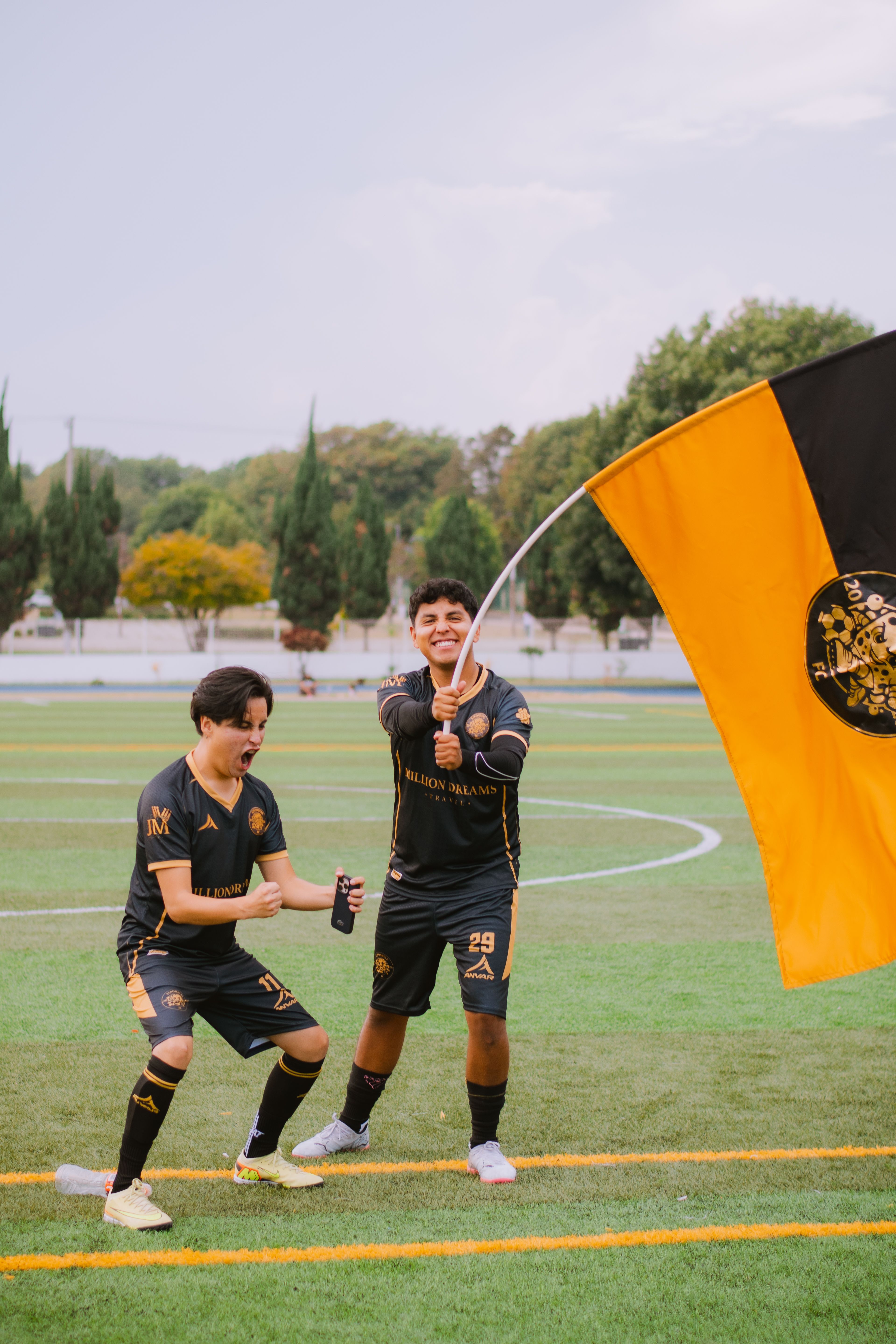 Close-up of a soccer ball moving between two opposing players in a defensive stance