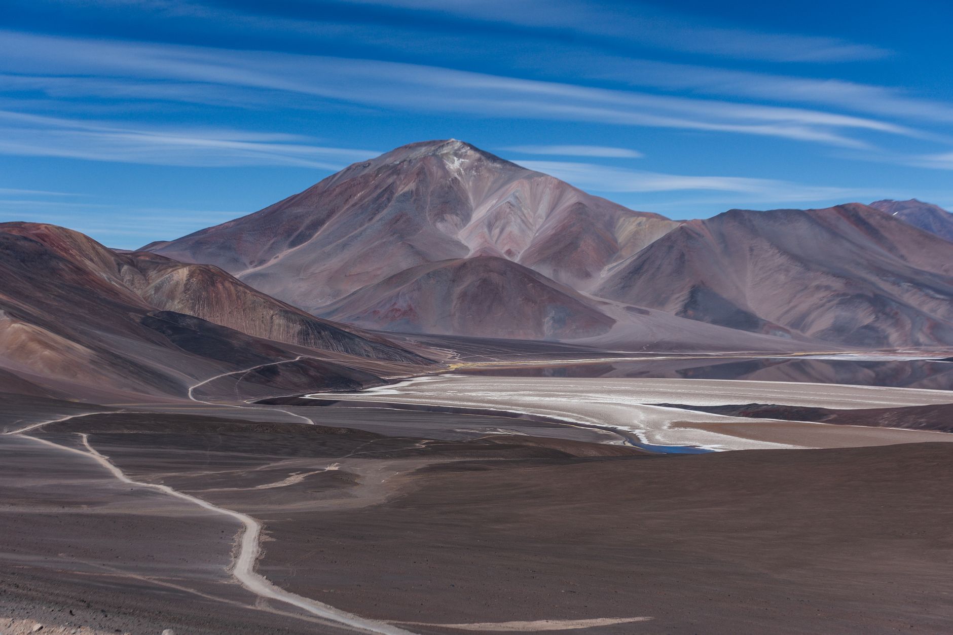 Breathtaking view of the Andes Mountains in Catamarca, Argentina, showcasing rugged terrain and clear blue skies.