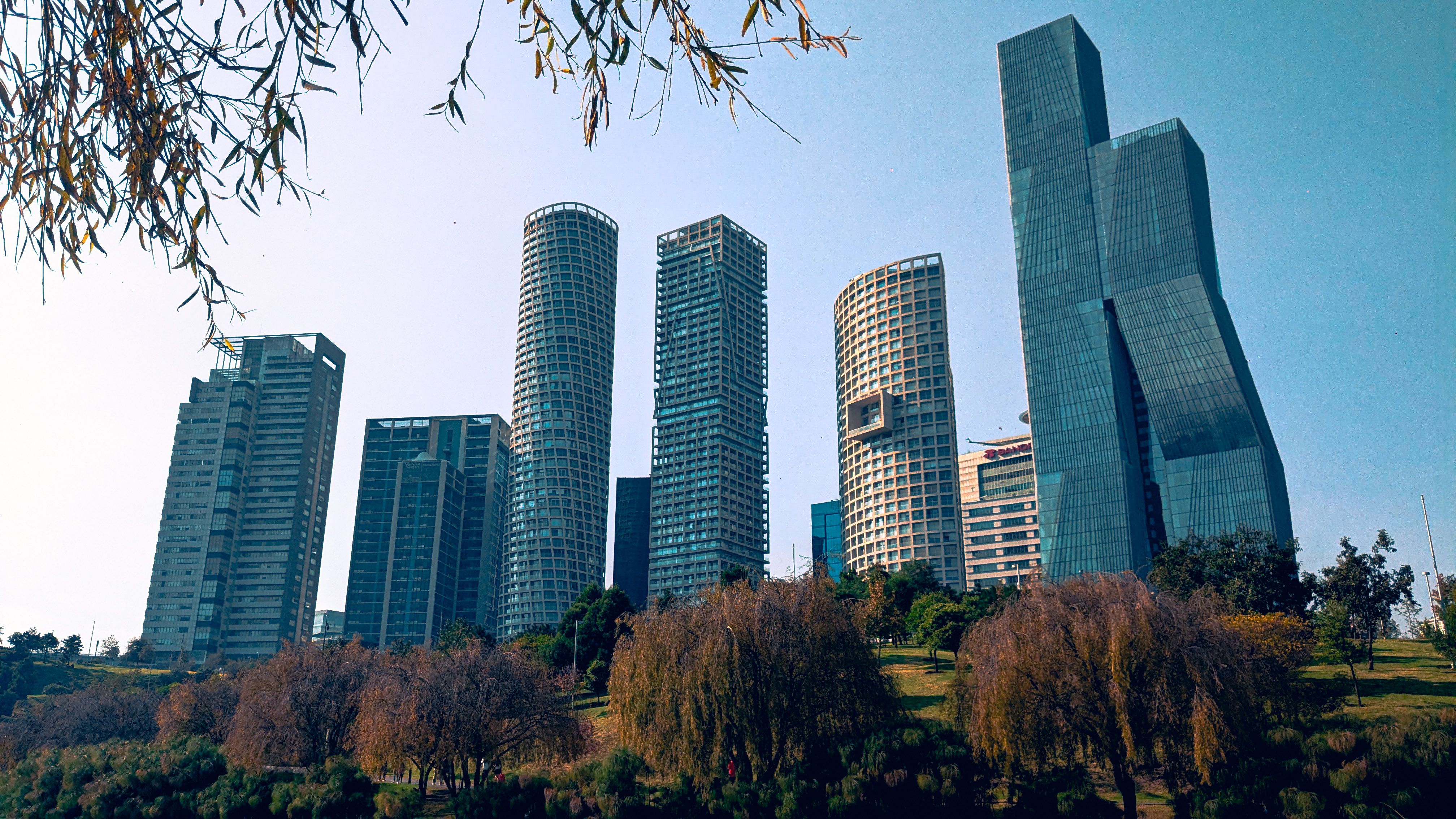 Skyline of modern skyscrapers set against a clear blue sky in Ciudad de México, vibrant urban landscape.