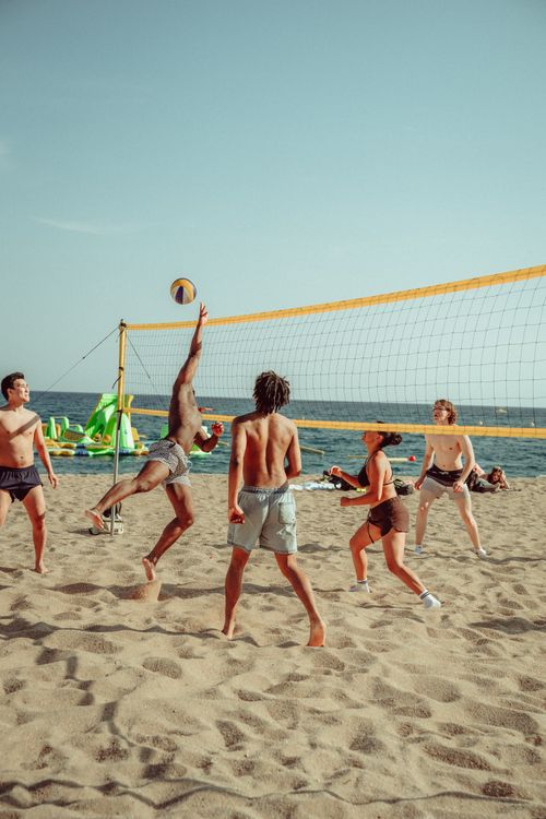 Free Energetic beach volleyball match with young adults at Lloret de Mar, Spain. Stock Photo