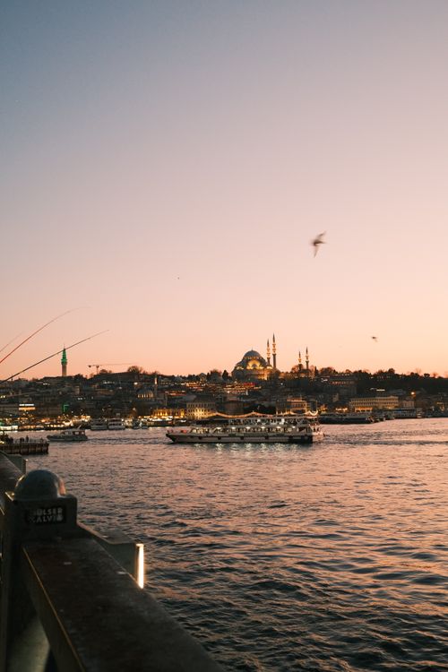 Free Beautiful sunset over Istanbul's Bosphorus with iconic skyline and boats. Stock Photo