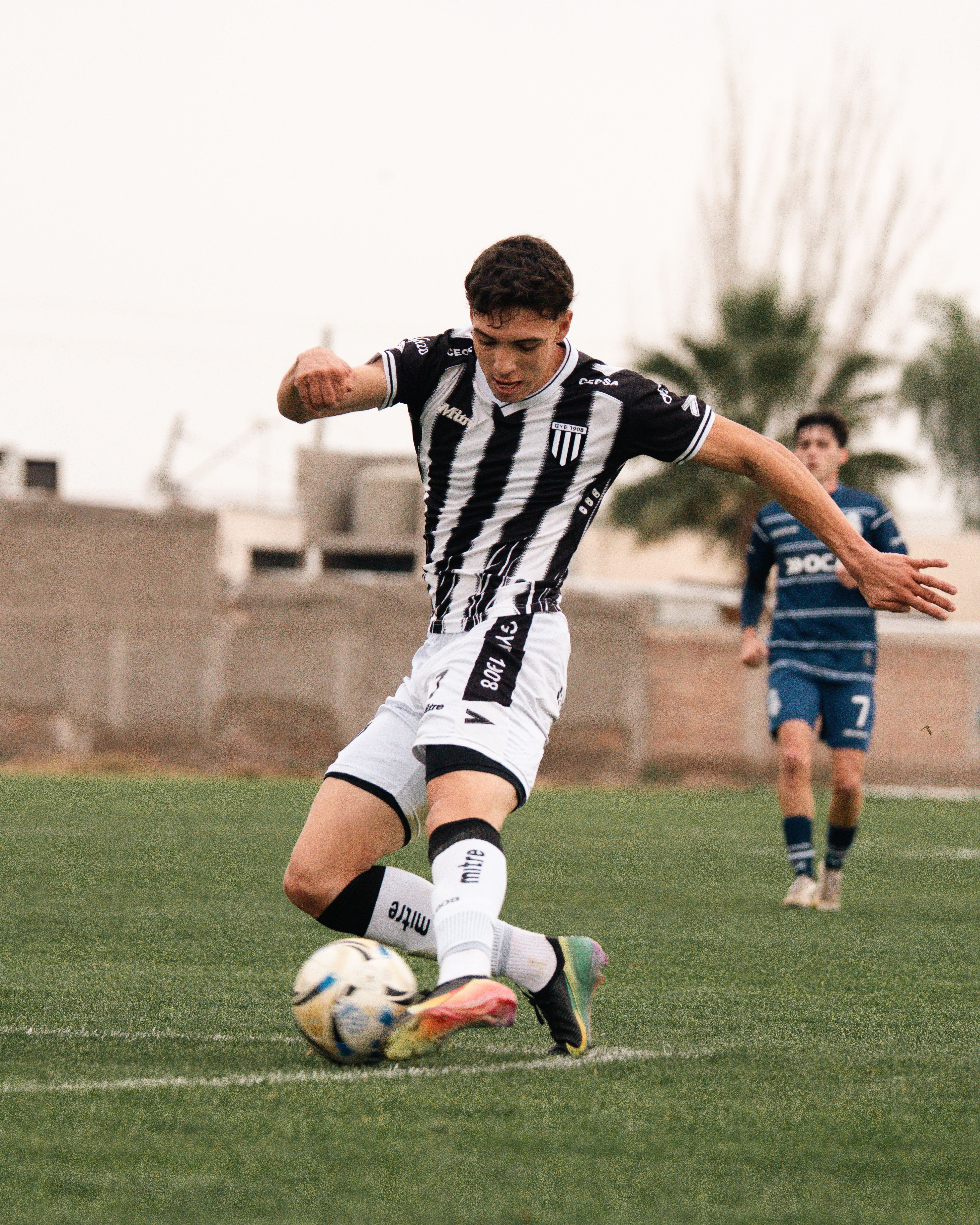 football player striking ball goal