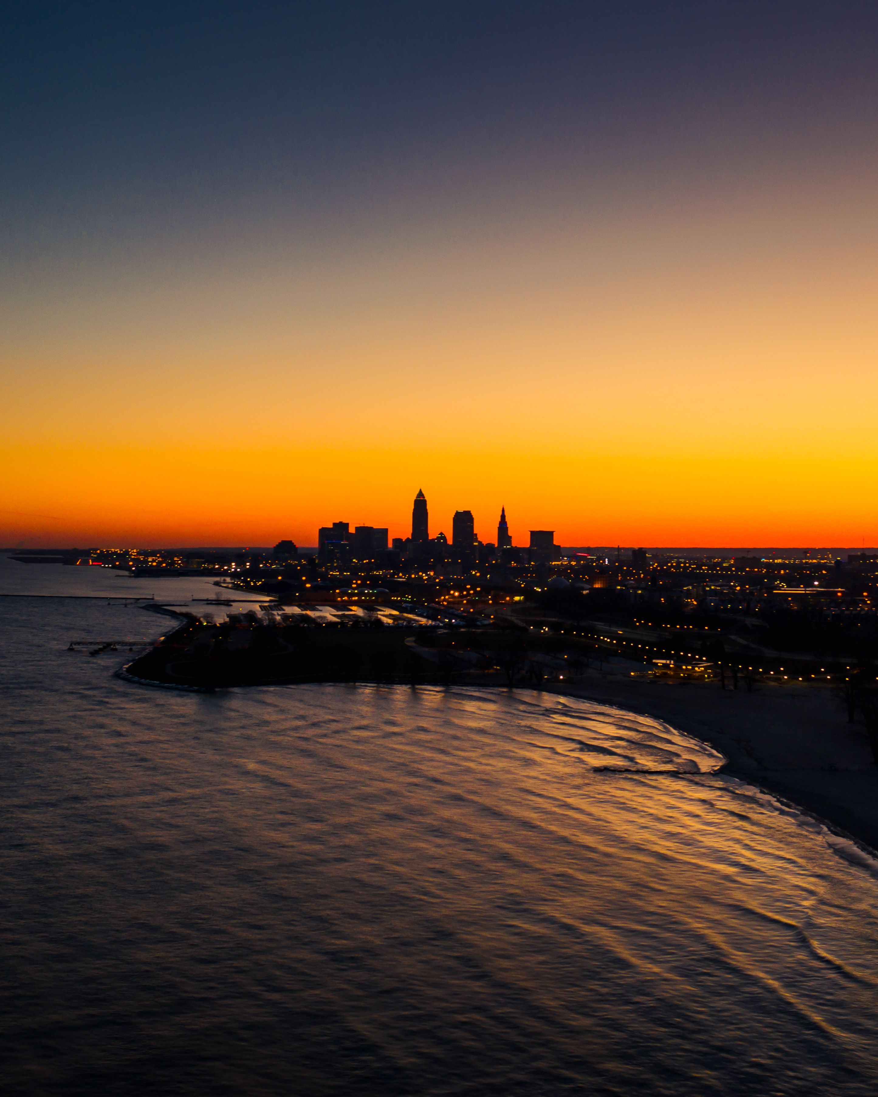 City Skyline Across Body of Water during Sunset · Free Stock Photo