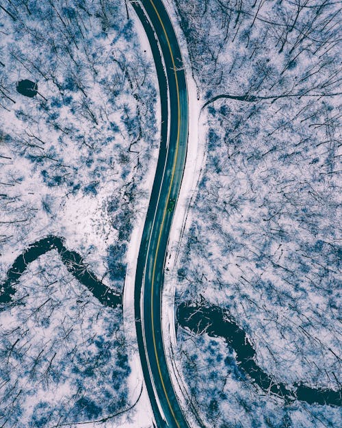 Aerial View of Road in the Middle of Snow Covered Ground