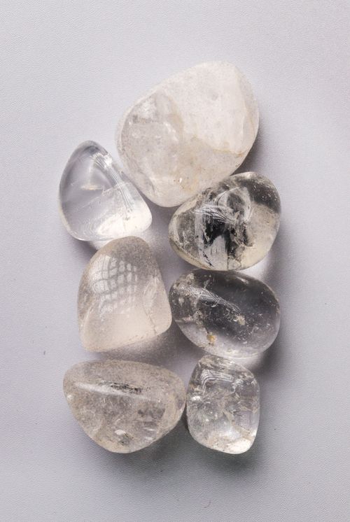 Free Top view of smooth polished quartz crystals on a neutral surface. Ideal for design or relaxation themes. Stock Photo