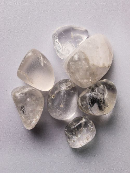 Free High-quality, tumbled clear quartz crystals against a soft background, showcasing natural beauty. Stock Photo