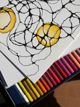 Close-up of abstract drawing with vibrant colored pencils and organic shapes.