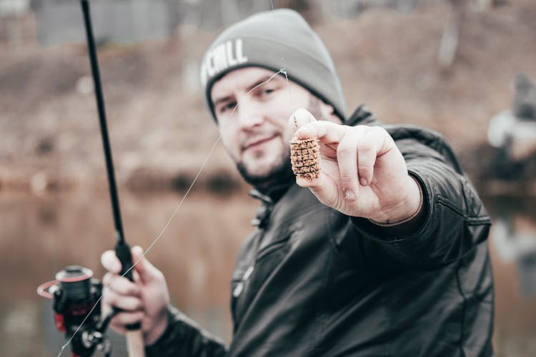 Man In Black Jacket Holding Fishing Bait