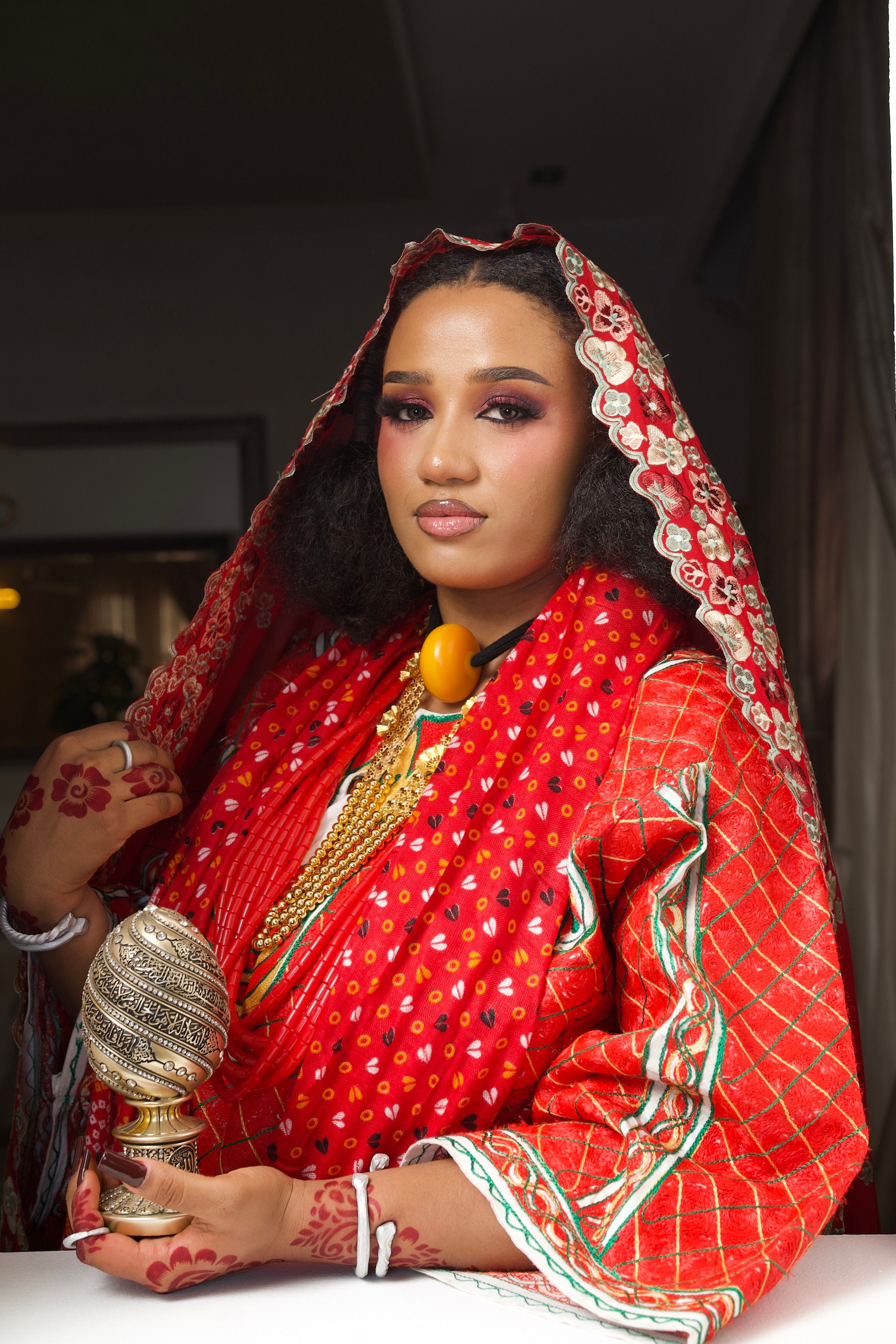 Elegant portrait of a Nigerian bride in traditional Hausa clothing with intricate jewelry.