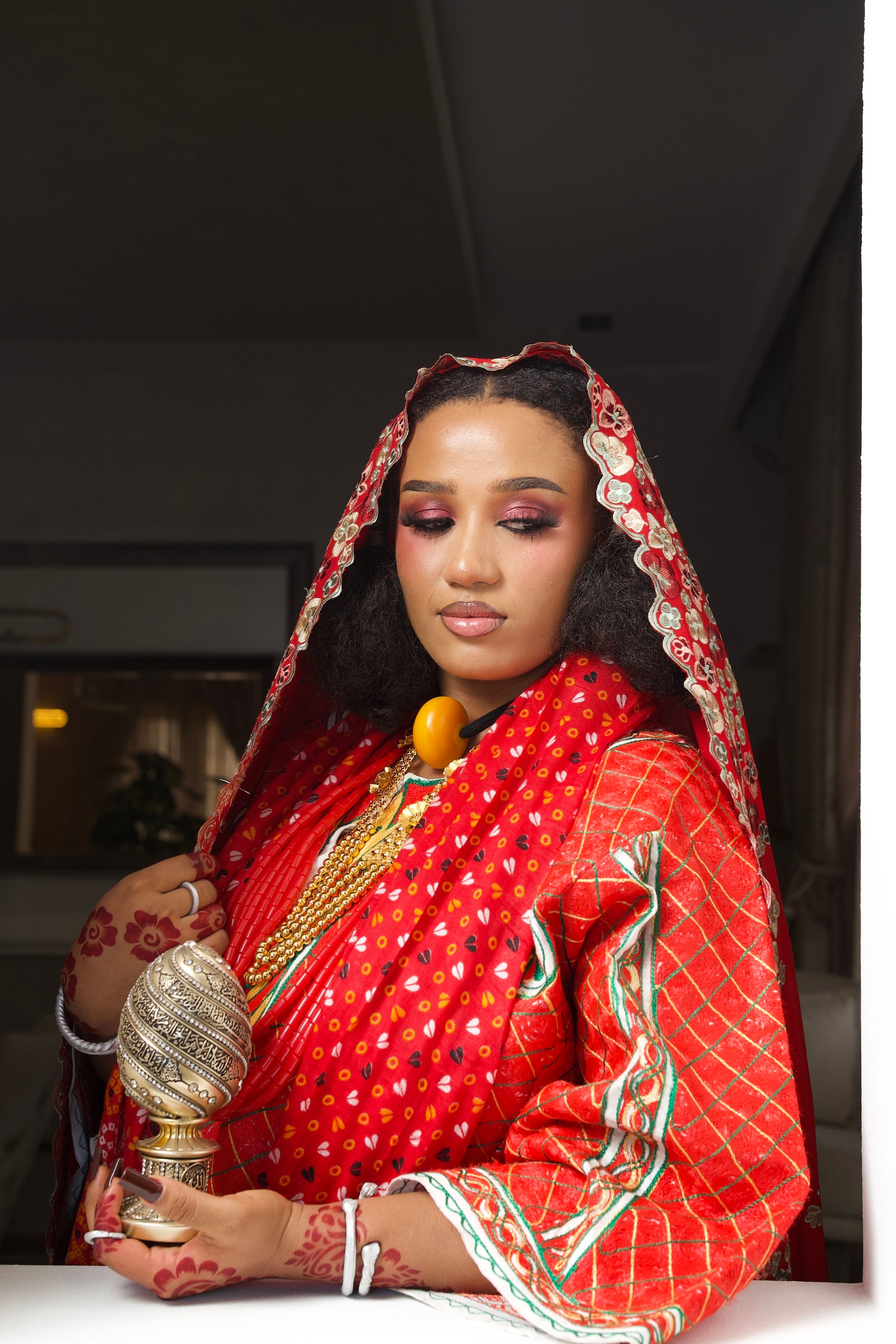 Beautiful Nigerian bride in vibrant red traditional attire, showcasing cultural heritage.
