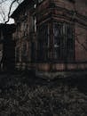 Facade of old gloomy house in evening