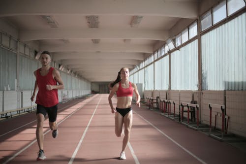 Photo of Man and Woman Running