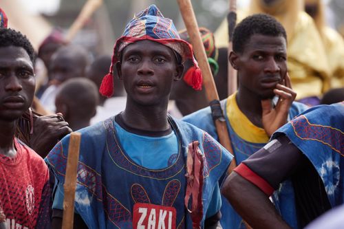 Free Men dressed in traditional attire at a vibrant cultural parade, showcasing rich cultural heritage. Stock Photo