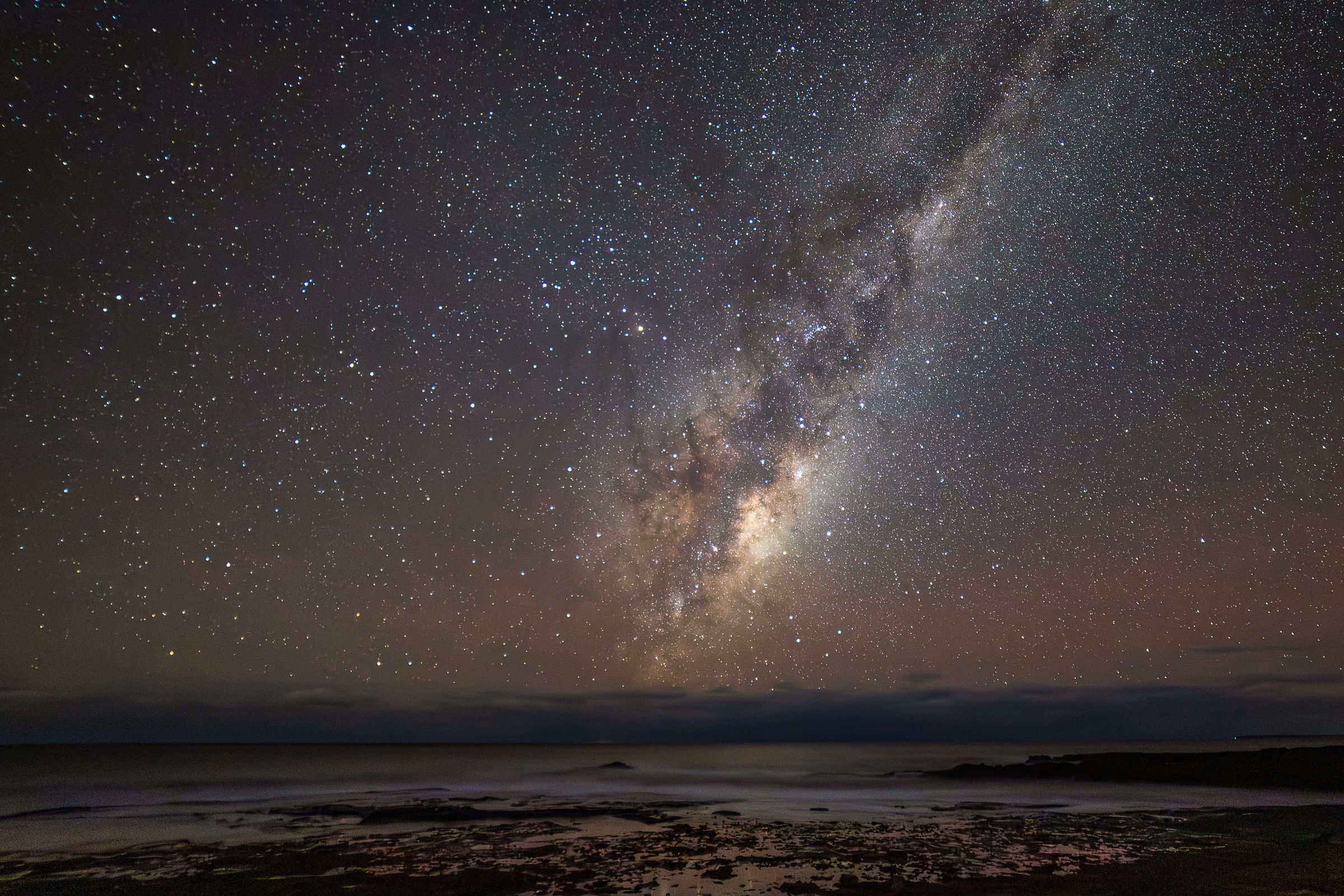 The southern Milky Way over an Australian beach