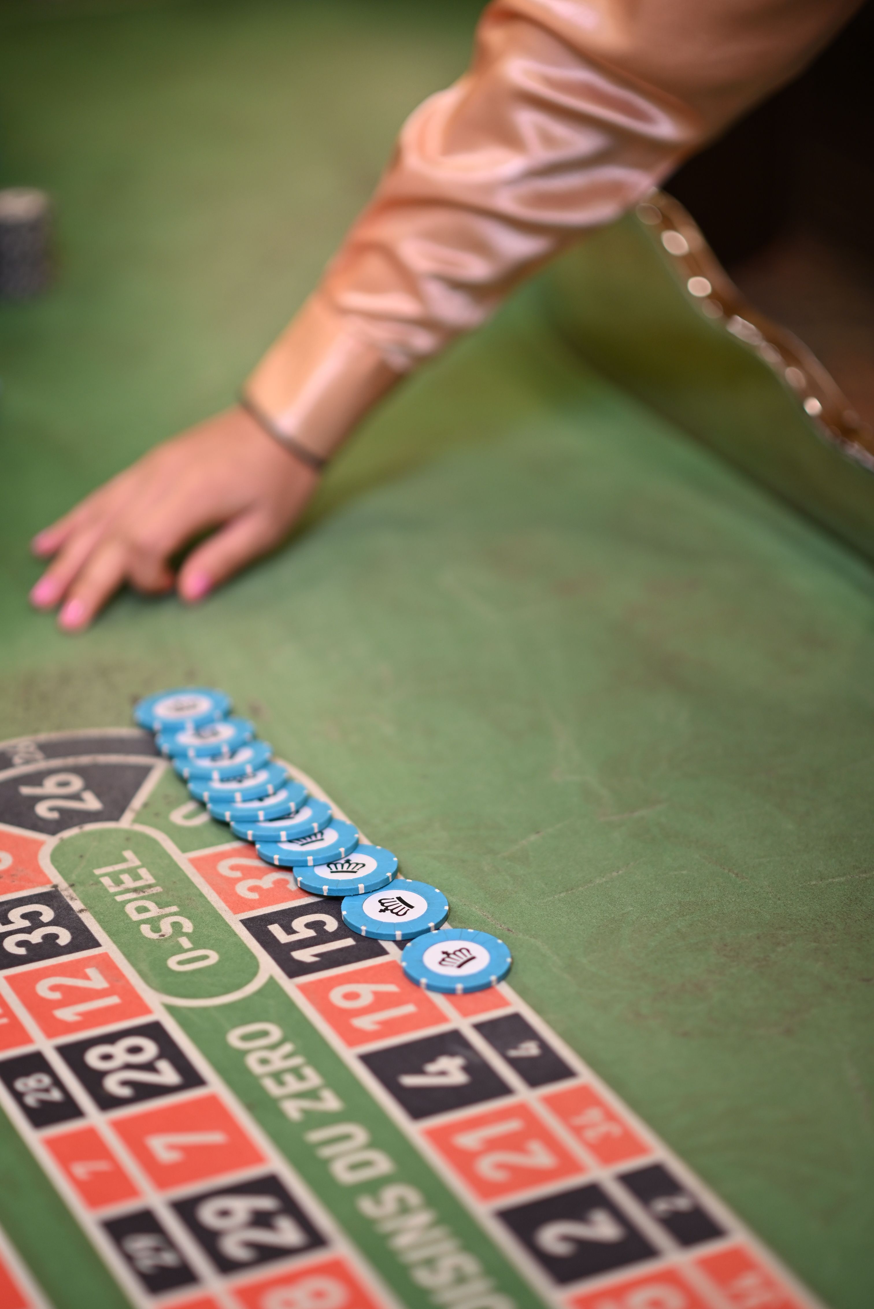 Close-up of blue casino chips on a roulette table in Candolim, Goa, India.