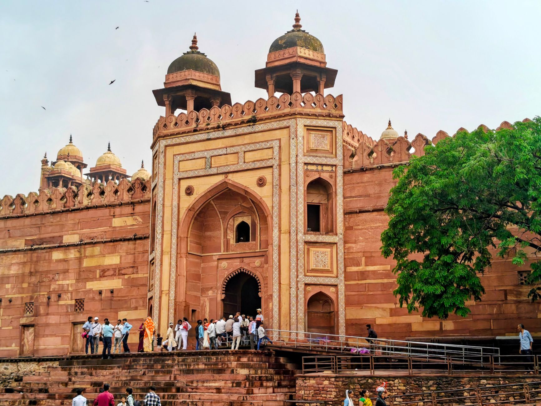 Tourists gather at the grand Buland Darwaza entrance in historic Fatehpur Sikri.
