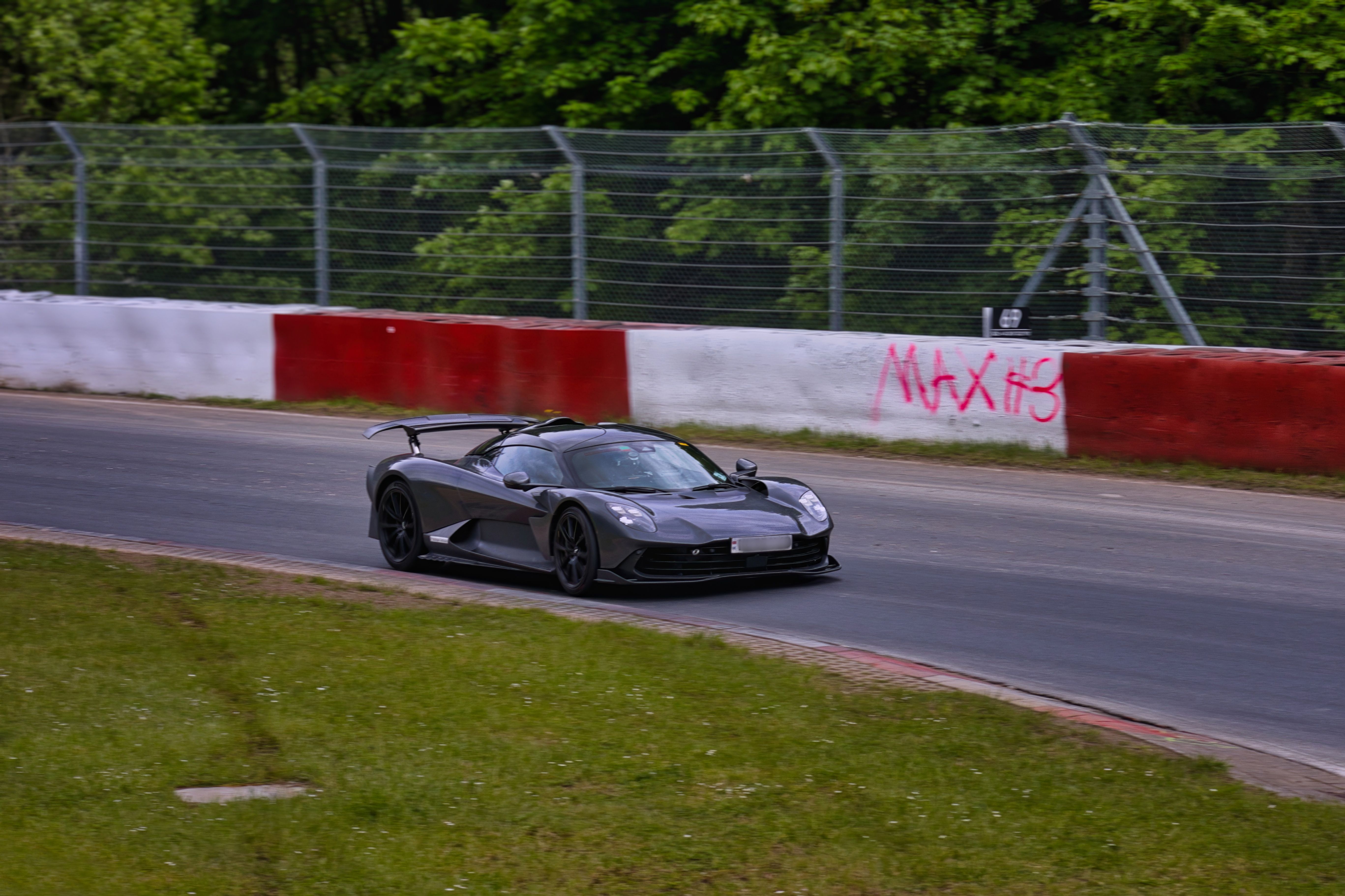 Sports car speeding on a race track demonstrating high-performance engineering.