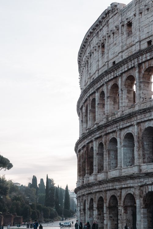 Free The iconic Colosseum in Rome captured beautifully at sunrise, showcasing its ancient grandeur. Stock Photo