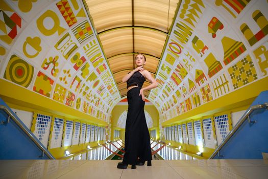 Striking fashion portrait in a vibrant geometric tunnel in Jakarta, Indonesia.