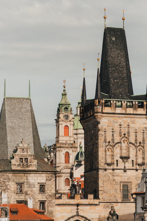 Free Capture of Prague's iconic historic architecture showcasing its unique Gothic style bathed in soft daylight. Stock Photo